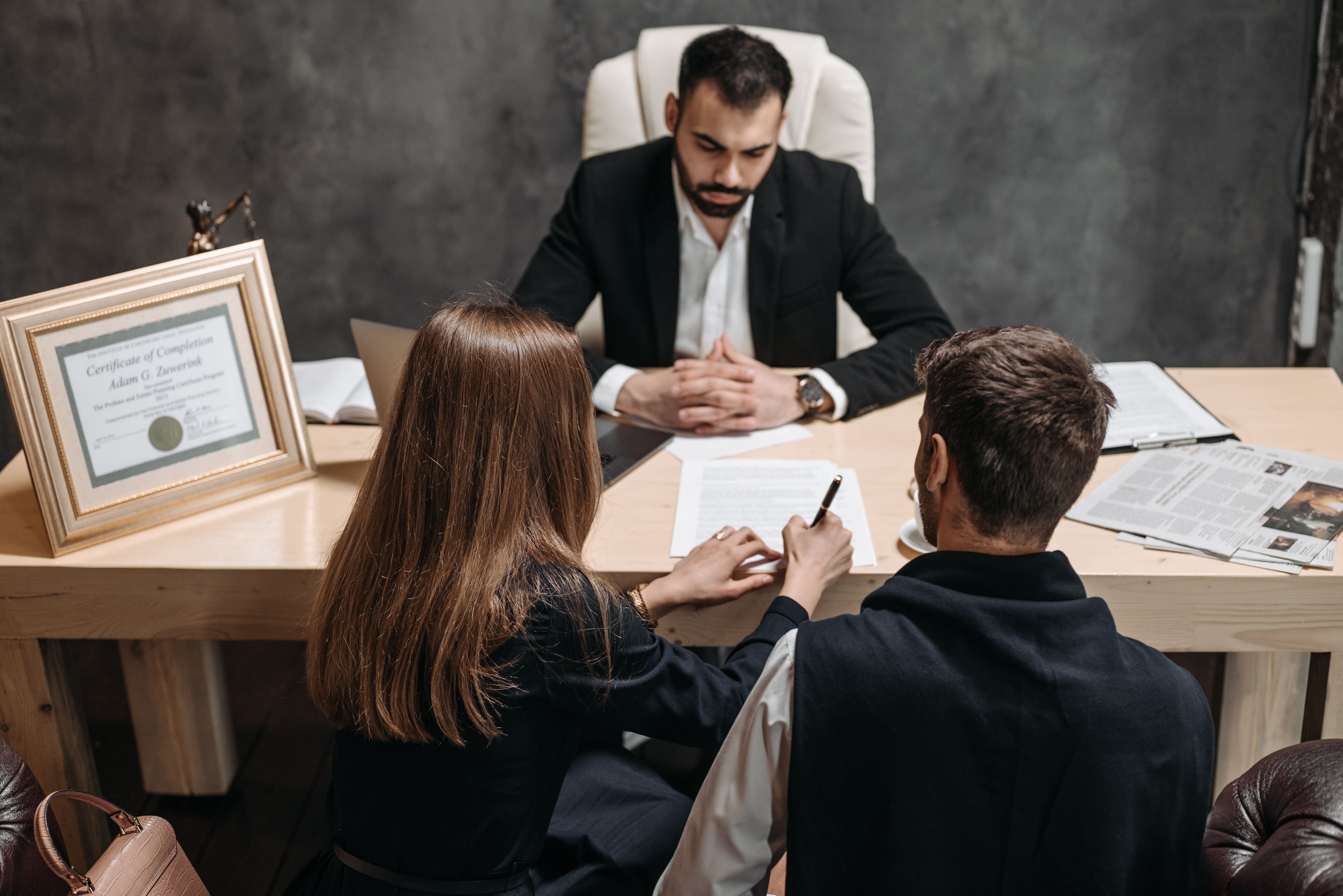 Lawyer discussing legal documents with clients in an office