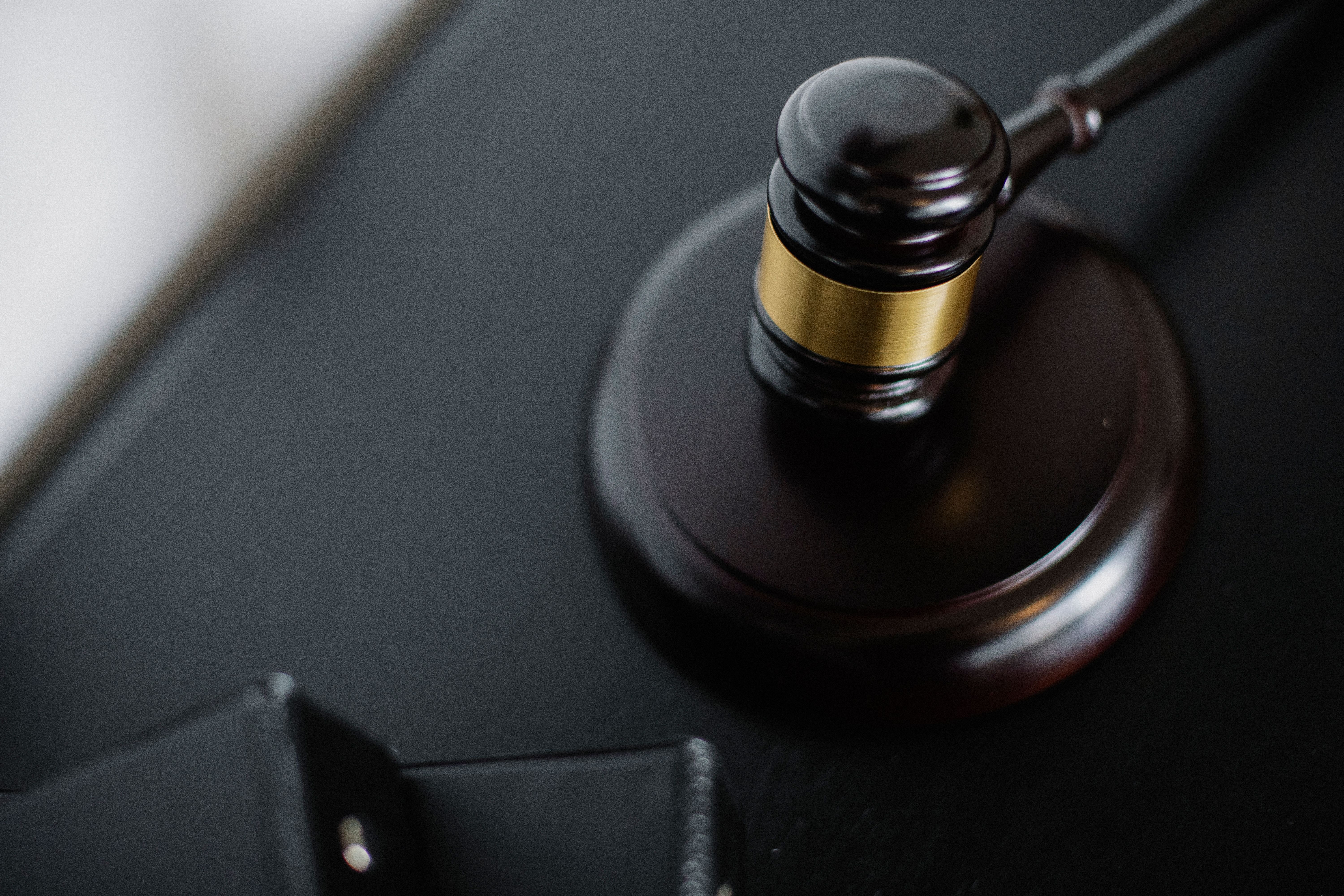 Overhead view of a wooden gavel beside case folders and court documents on a table
