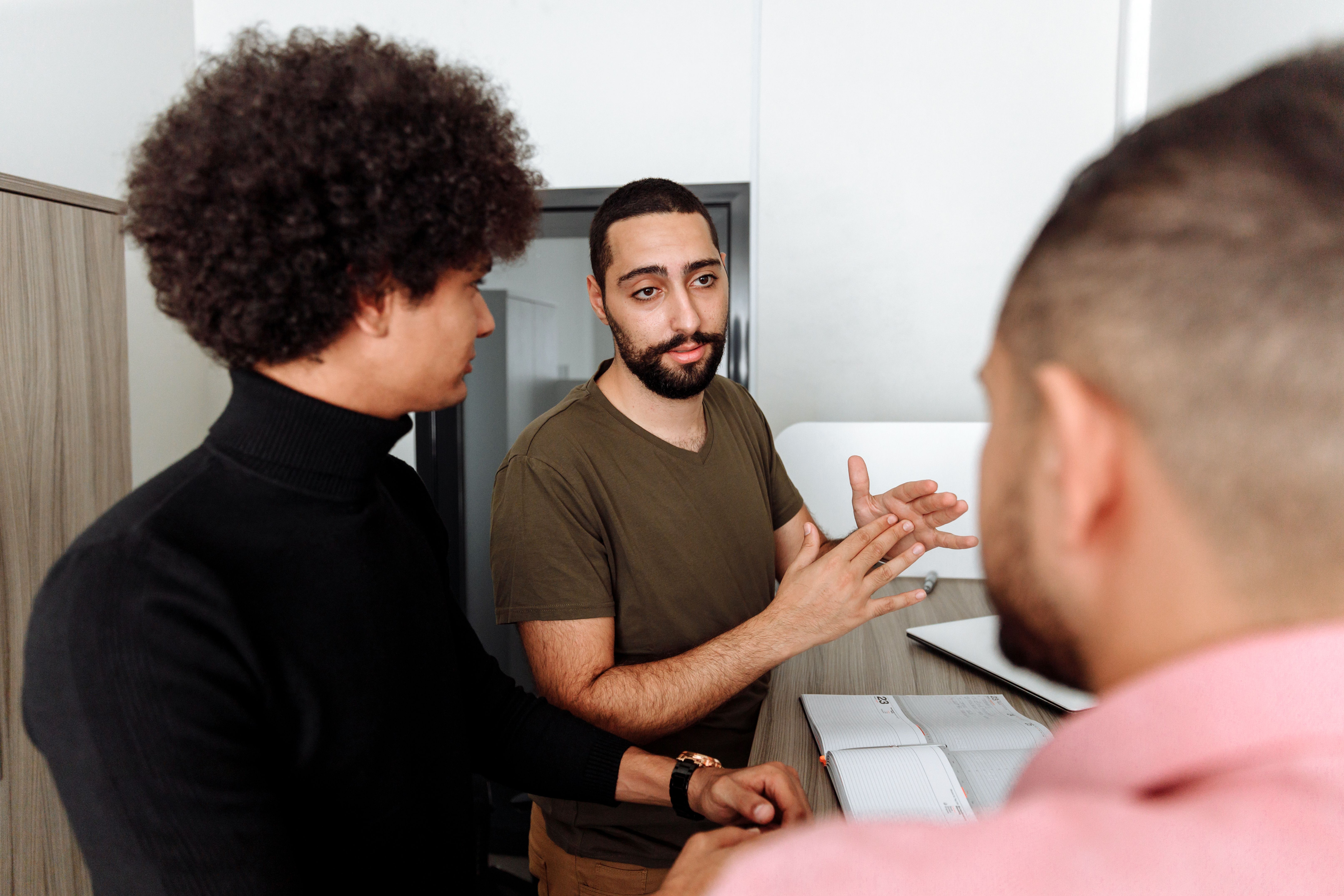 Group of people having a thoughtful discussion in a modern office