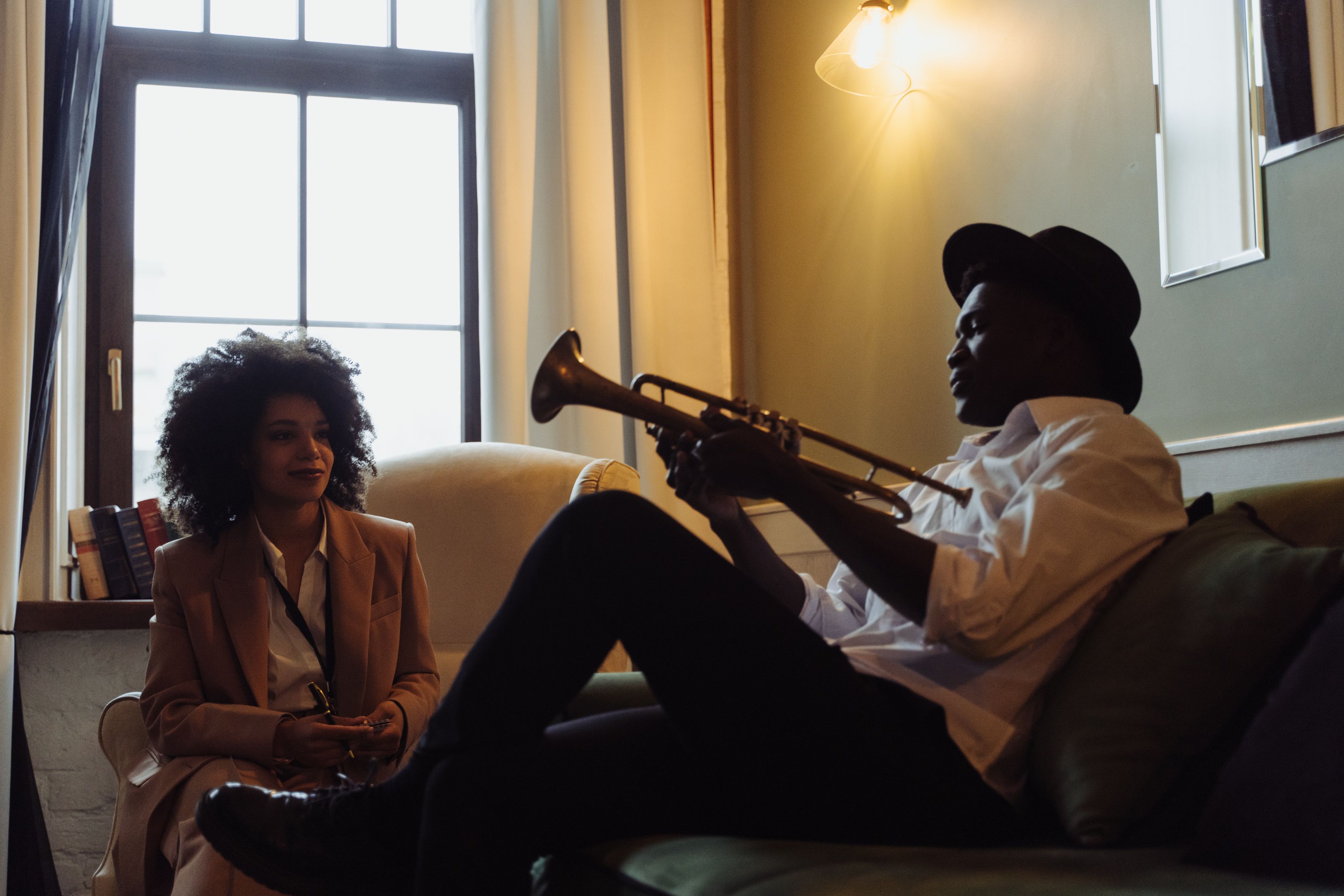 Musician speaking with a journalist, representing the conversations involved in artist representation and promotion.
